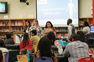 HSA at Monroe Middle student receiving her certificate of completion